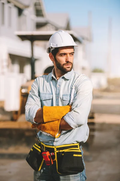 Portrait of caucasian man construction worker wearing hardhat and safety equipment, civil engineers foreman working at construction site.