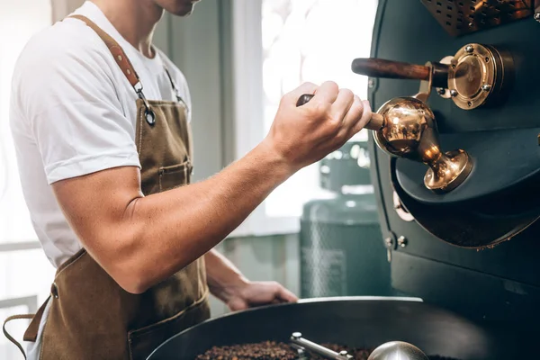 Small Business Owner\'s Caucasian Male Working in Coffee Beans Warehouse, Quality Coffee Production, Small Business Owner\'s Expertise in Coffee Roasting.