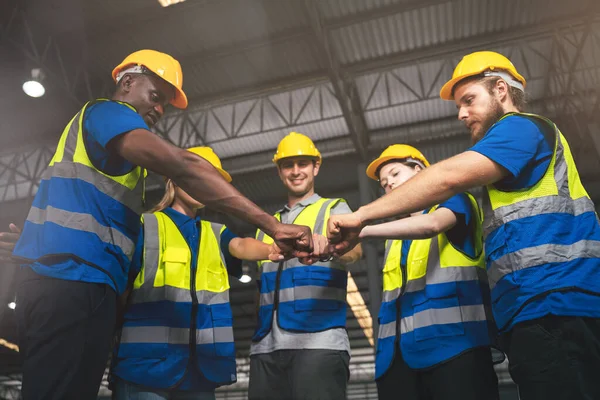 Group of Diverse Warehouse Workers Join Hands Together To Making Team Spirit, Industrial Management and Teamwork for Optimal Efficiency.