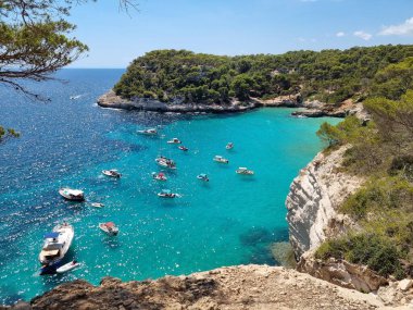 View of turquoise sea in beautiful bay Cala Mitjaneta in Menorca Spain