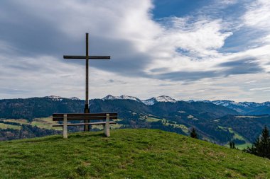 Spring hike on the Thaler and Salmaser Hoehe in Immenstadt with a view of the Alpsee in the beautiful Allgau Alps clipart