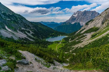 Panoramic mountain tour in Ehrwald via the Tajatorl to Drachensee, Coburger Hut and Seebensee in the Tiroler Zugspitz Arena clipart