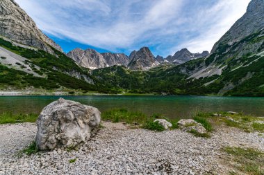 Panoramic mountain tour in Ehrwald via the Tajatorl to Drachensee, Coburger Hut and Seebensee in the Tiroler Zugspitz Arena clipart