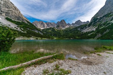 Panoramic mountain tour in Ehrwald via the Tajatorl to Drachensee, Coburger Hut and Seebensee in the Tiroler Zugspitz Arena clipart