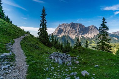 Panoramic mountain tour in Ehrwald via the Tajatorl to Drachensee, Coburger Hut and Seebensee in the Tiroler Zugspitz Arena clipart