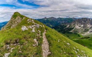 Beautiful mountain tour in Bad Hindelang to the Breitenberg and Rotspitze summit with a short via ferrata over the Hohe Gaenge clipart