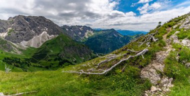 Beautiful mountain tour in Bad Hindelang to the Breitenberg and Rotspitze summit with a short via ferrata over the Hohe Gaenge clipart