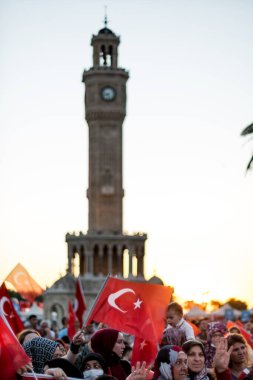 Izmir, Turkey - July 15, 2022: July 15 Day of Democracy in Turkey Izmir. Poeple holding Turkish flags at Konak square in Izmir and in front of the historical clock tower. clipart