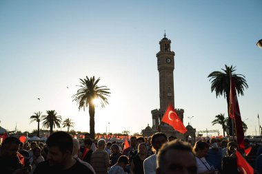İzmir, Türkiye - 15 Temmuz 2022: 15 Temmuz İzmir Demokrasi Günü. İzmir 'deki Konak Meydanı' nda ve tarihi saat kulesinin önünde Türk bayrakları taşıyan çan kulesi.