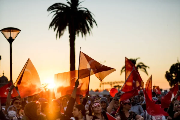 stock image Izmir, Turkey - July 15, 2022: July 15 Day of Democracy in Turkey Izmir. Poeple holding Turkish flags at Konak square in Izmir and in front of the historical clock tower.