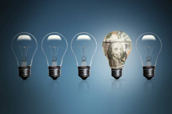 Five Lightbulbs Blue Background One Them Wrapped Some 100 Dollars — Stock Photo, Image