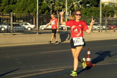 İzmir, Türkiye - 11 Eylül 2022: Yarı maratonda hareket bulanıklığı çeken kadın, İzmir 'in kurtuluşunun 100. yıldönümü için özel koşuyor.