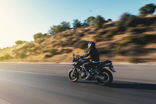 骑在高速公路上的摩托车手的侧视图 运动模糊 — 图库照片