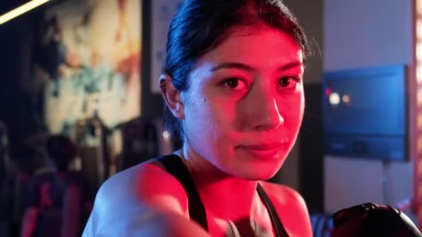 Kvindelig Atlet Iført Boksehandsker Kaster Fokuseret Slag Mod Kameraet Træningscenter – Stock-video
