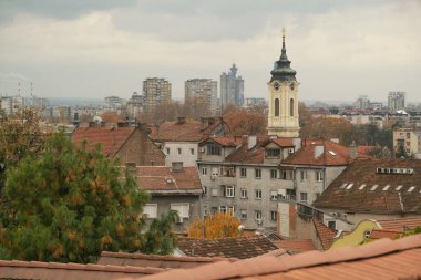 Belgrade, Serbia - December 3, 2023: An overcast view captures the varied urban landscape, punctuated by the iconic Zemun Tower and distant church spires clipart