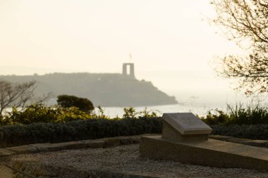 Canakkale, Turkey - Mar 18 2024: Photo of the Lieutenant Colonel Charles Doughty-Wylie memorial in Seddulbahir village on the Gallipoli Peninsula, with the Martyrs' Memorial visible in the background. clipart