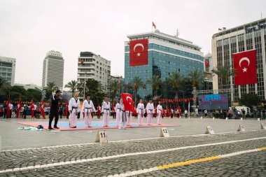 İzmir, Türkiye - 19 Mayıs 2024: Tekvando öğrencileri Cumhuriyet Meydanı 'nda Gençlik ve Spor Günü ve Atatürk Anma Günü kutlamaları sırasında tatamide gösteri yaptılar