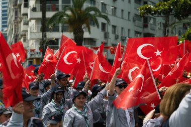İzmir, Türkiye - 19 Mayıs 2024: Cumhuriyet Meydanı 'nda Gençlik ve Spor Günü ve Atatürk Anma Günü kutlamaları sırasında Türk bayraklarıyla yürüyüş yapan izciler