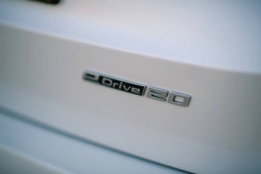 İzmir, Türkiye - 11 Kasım 2024: BMW IX1 eDrive 20 rozetine yakın çekim, çevre dostu markalaşma ve modern elektrikli araç tasarımı.