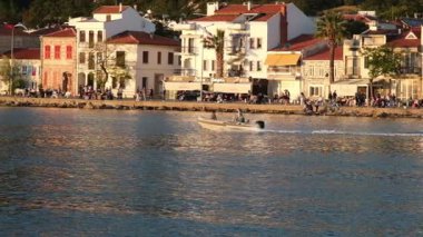İzmir, Türkiye - 4 Mayıs 2025: Foca 'da 2 yolcuyla birlikte denizde seyreden motorlu şişirilebilir bir teknenin yavaş çekim videosu