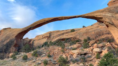 Dünyanın en uzun doğal taş kemerlerinden biri olan Peyzaj Kemeri, Utah Arches Ulusal Parkı 'nda. Kırmızı kayalar parlak mavi gökyüzü ile çok güzel tezat oluşturuyor.