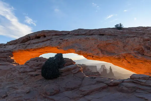 stock image Breathtaking orange sunrise illuminating the under glow of Mesa Arch in Canyonlands National Park, Utah. Capturing the serene beauty of the desert landscape and natural rock formations - USA