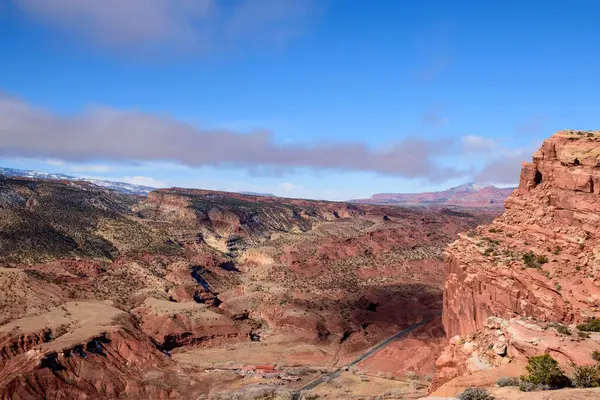 stock image Stunning aerial view of Capitol Reef National Park in Utah, showcasing expansive red rock formations, rugged terrain, and a bright blue sky - Fruita District, USA