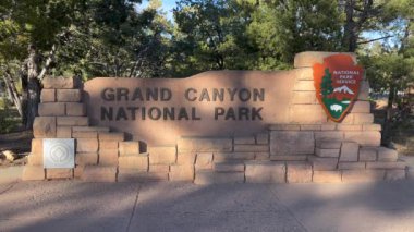 Grand Canyon Village, Arizona, ABD - 03.21.2024: Grand Canyon Ulusal Parkı South Rim giriş işareti. Tabela taştan yapılmış ve Milli Park Servis logosu var.. 