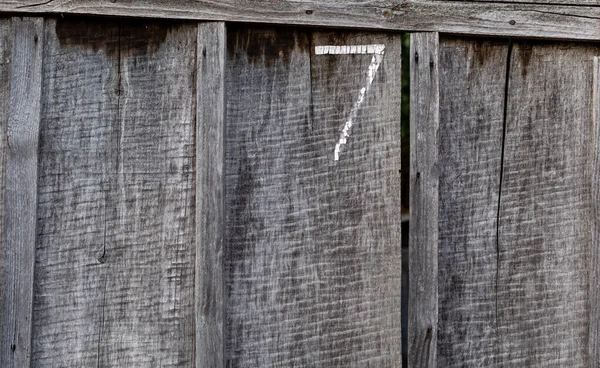 Fence Made Rough Old Unpainted Wooden Boards Number Painted Vertical — Stock Photo, Image