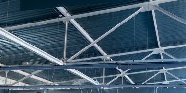 Industry. Lightweight load-bearing metal roof structures inside an industrial facility clipart