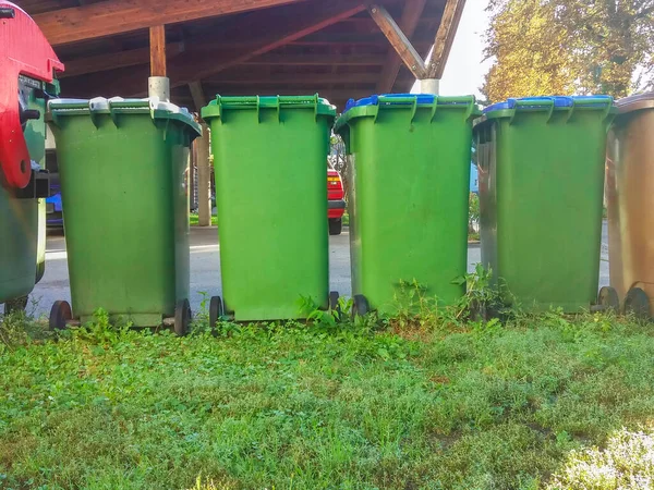 stock image Garbage cans in different colors for waste management, trash recycling bins on the street