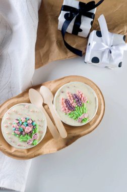 Beyaz tek kullanımlık kahve fincanlarıyla şirin dekorlu ev yapımı mini kek, yeni şekerleme modası. Pastalı kâğıt bardaklar bir kutuda, güzel bir tatlı.