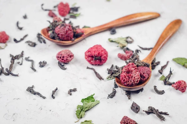 stock image Dried fruit green tea with raspberries on vintage wooden tea spoons over white background with copy space negative space. 