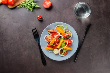 Healthy salad with red and yellow cherry tomato, sesame and parsley in plate. Summer food concept. Selective focus