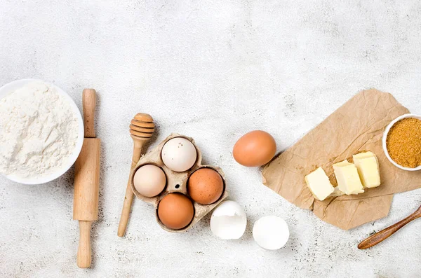 stock image Baking homemade cookies on gray kitchen worktop with ingredients -flour, eggs,  sugar and  cinnamon. culinary background, copy space, overhead view