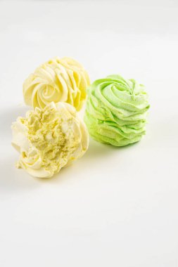 Colorful zephyrs on a white background. Perfect for food photography, dessert, and sweet treats. clipart