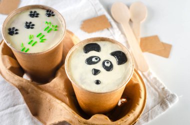 Cute panda-themed cake to go in eco-friendly cups. Perfect for food blogs, social media, and product packaging. clipart