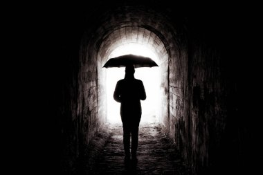 young girl with black umbrella in the tunnel, light at the end of the tunnel clipart