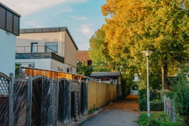 Old white cottage in cozy town. Street view landscape old city, little houses on sunset. Old architecture street front view. Calm old town street. Stone white pink rural cottages and summer gardens.