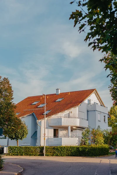 Old white cottage in cozy town. Street view landscape old city, little houses on sunset. Old architecture street front view. Calm old town street. Stone white pink rural cottages and summer gardens.