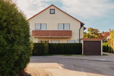 Old white cottage in cozy town. Street view landscape old city, little houses on sunset. Old architecture street front view. Calm old town street. Stone white pink rural cottages and summer gardens.