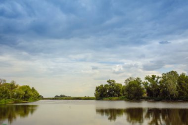 beautiful lake at the evening. Landscape - meadow, the blue sky and river.