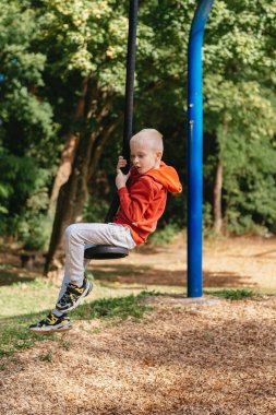 Çocuk parkında oynayan komik, sevimli, mutlu bebek. Mutluluk duygusu, eğlence, neşe. Bir çocuğun gülümsemesi. Çocuk parkta oynuyor..