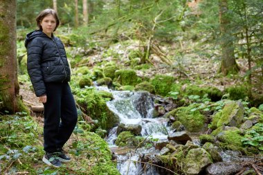 Yükselen manzaranın tepesindeki genç turist kadın. Yürüyüş yapan kadın dinleniyor. Kafkasyalı güzel bir kadın günlük kıyafetler giyiyor, maceralar yaşıyor yalnız seyahat ediyor ve dağların tepesinde yürüyüş yapıyor.