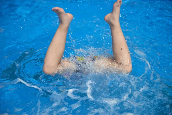 stock image Fit swimmer training in the swimming pool. An overhead view of a man diving into a pool, forming an arrow shape and leaving a trail behind him. Professional male swimmer inside swimming pool. Young