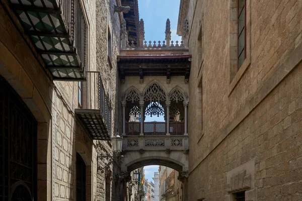 stock image Bridge between buildings in Barri Gotic quarter of Barcelona, Spain. Pont del Bisbe at Dawn - A morning view of a neo-Gothic style stone bridge, 