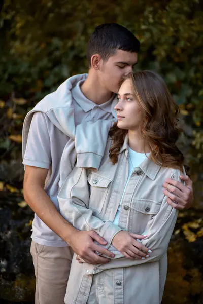 stock image Young Cute Female Hugs Boyfriend. In Autumn Outdoor. Lovers Walking in Park. Attractive Funny Couple. Lovestory in Forest. Man and Woman. Cute Lovers in the Park. Family Concept. Happy Couple.