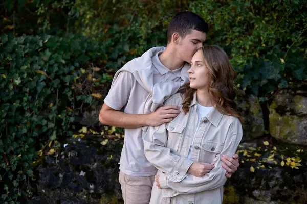 stock image Young Cute Female Hugs Boyfriend. In Autumn Outdoor. Lovers Walking in Park. Attractive Funny Couple. Lovestory in Forest. Man and Woman. Cute Lovers in the Park. Family Concept. Happy Couple.