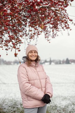 Winter Elegance: Portrait of a Beautiful Girl in a Snowy European Village clipart