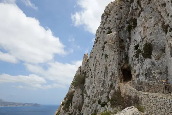 stock image Ancient Rock Tunnel Framing Breathtaking Ocean Vista: Natures Gateway to Hidden Coastal Wonders